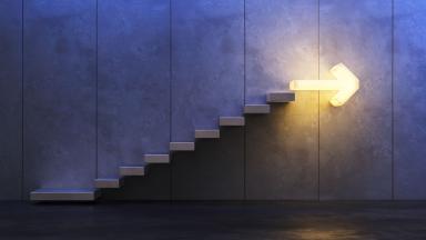 Stairs going upwards with bright arrow at the top